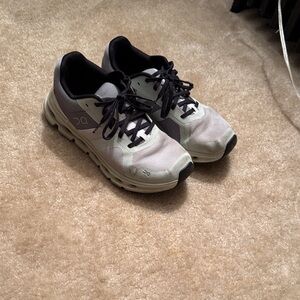 On Running Cream and Black Athletic Shoes